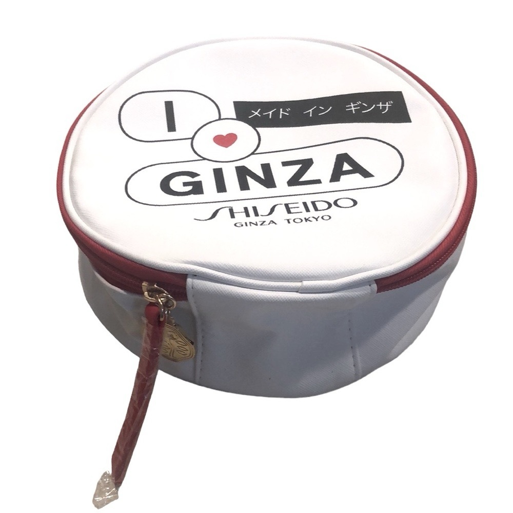 SHISEIDO ROUND ZIPPERED MAKEUP BAG WITH BLK RED AND WHITE REVERSE PRINT